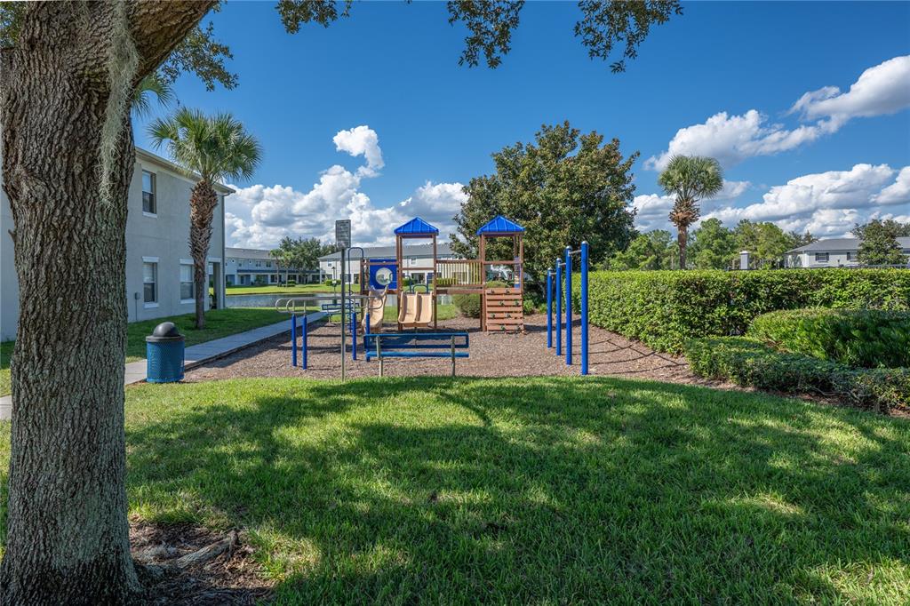 9441 Flowering Cottonwood Road, Unit 41 Orlando, FL 32832 - Photo 29 of 31 a view of a bench in a yard