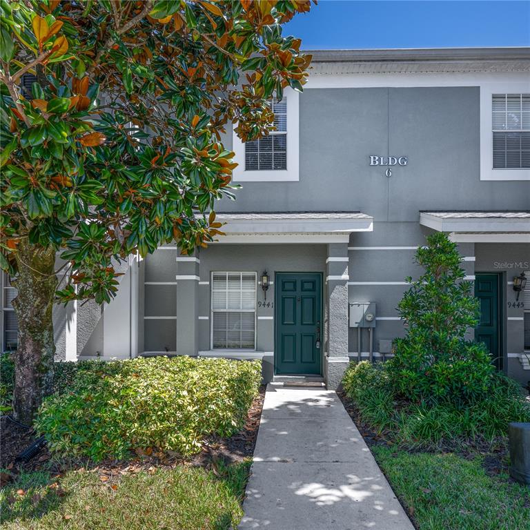 9441 Flowering Cottonwood Road, Unit 41 Orlando, FL 32832 - Photo 3 of 31 front view of a house with a yard