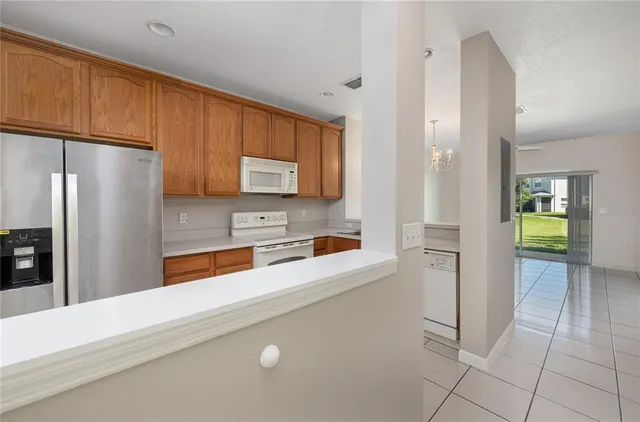 a kitchen with stainless steel appliances a refrigerator sink and cabinets