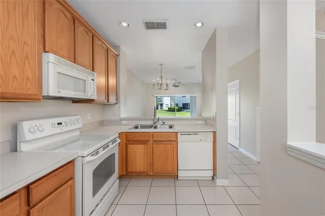 a kitchen with a stove a sink and a refrigerator
