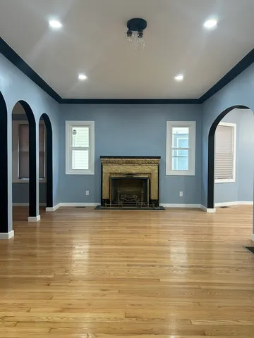 a view of empty room with fireplace and window