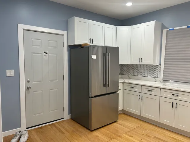 a kitchen with cabinets and stainless steel appliances