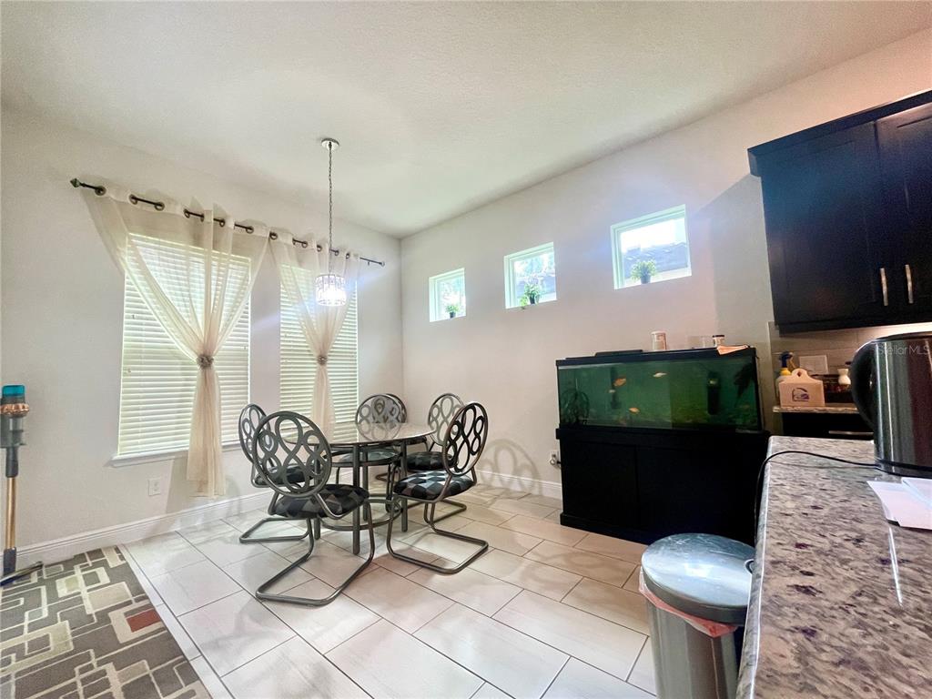 16611 Toccoa Row Winter Garden, FL 34787 - Photo 11 of 31 a living room with furniture and a chandelier