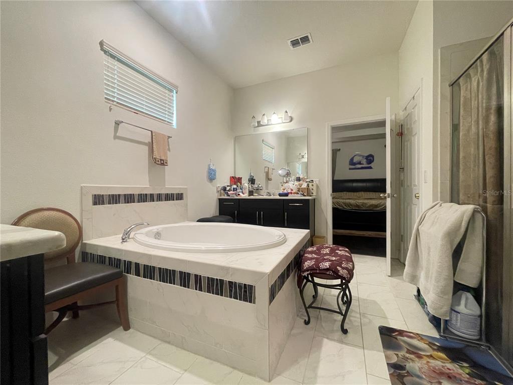 16611 Toccoa Row Winter Garden, FL 34787 - Photo 17 of 31 a room with a table chairs and a refrigerator