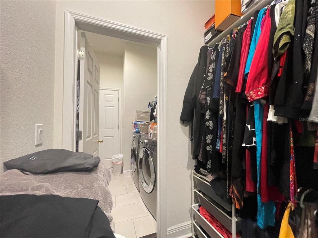 16611 Toccoa Row Winter Garden, FL 34787 - Photo 18 of 31 a bed room with a bed a desk and a closet