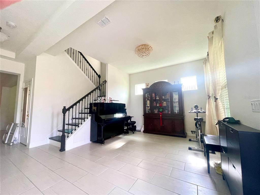 16611 Toccoa Row Winter Garden, FL 34787 - Photo 2 of 31 a living room with furniture and a chandelier