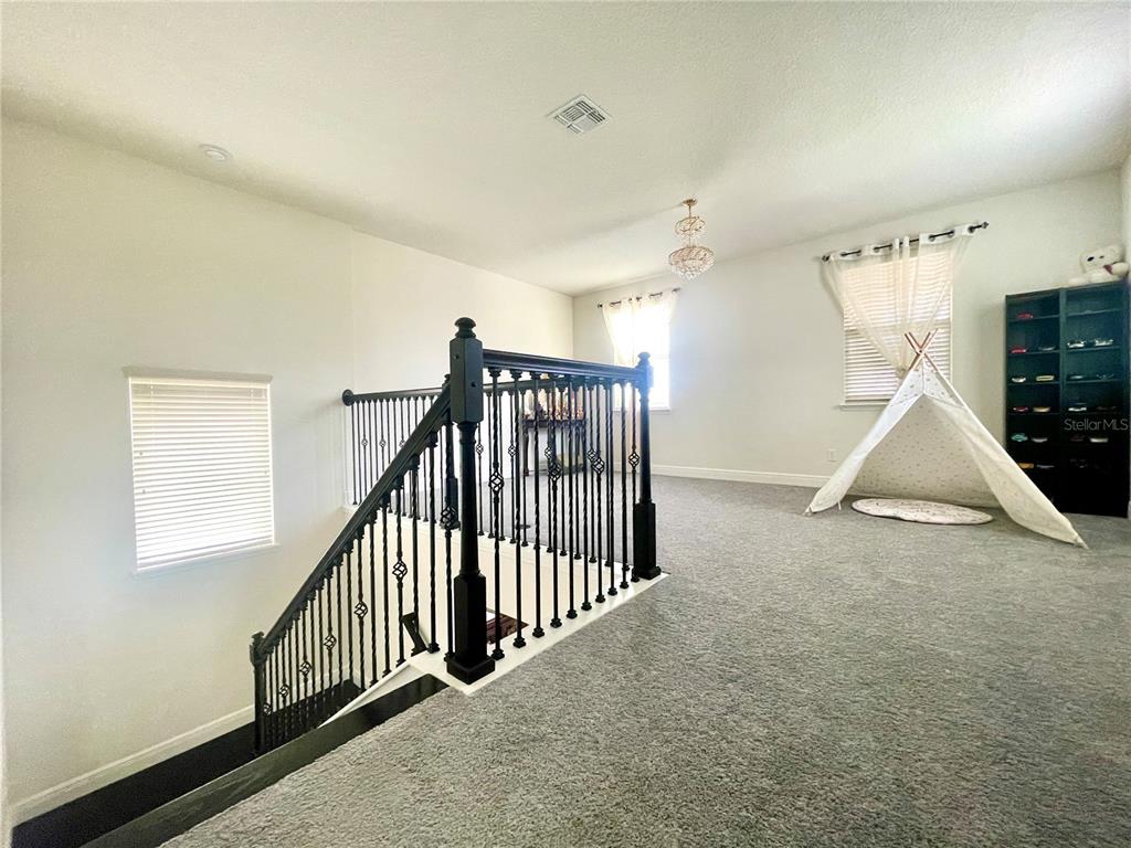 16611 Toccoa Row Winter Garden, FL 34787 - Photo 22 of 31 a view of a hallway with stairs and windows
