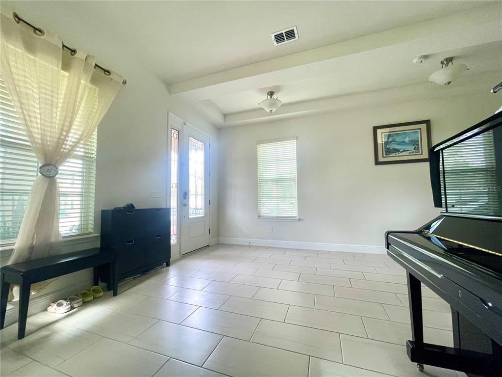 16611 Toccoa Row Winter Garden, FL 34787 - Photo 4 of 31 a living room with furniture and a flat screen tv