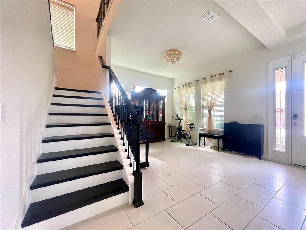 16611 Toccoa Row Winter Garden, FL 34787 - Photo 5 of 31 a view of entryway with livingroom and stairs