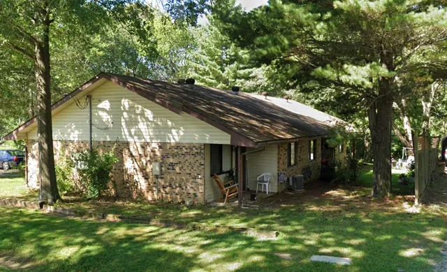 a backyard of a house with table and chairs