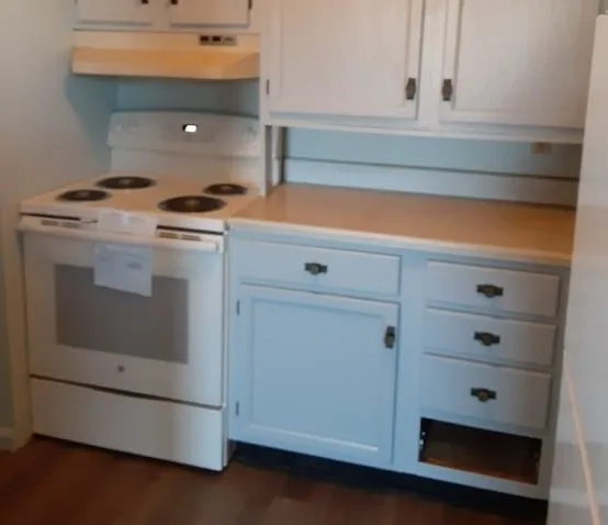 a kitchen with cabinets and appliances