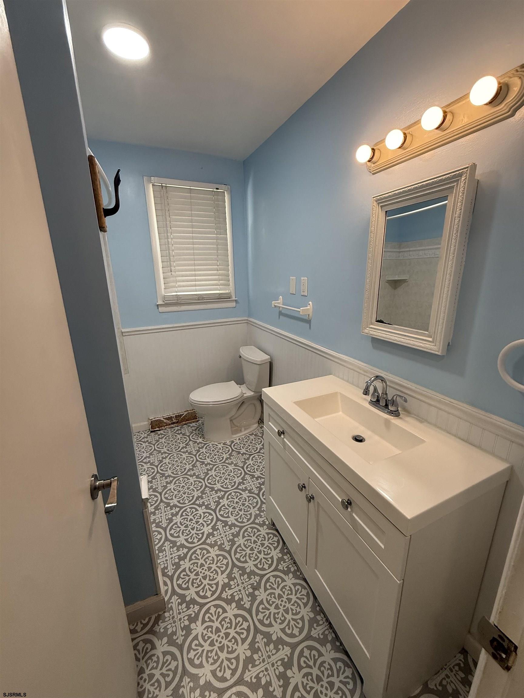 230 Bethel Road Somers Point, NJ 08244 - Photo 18 of 30 a bathroom with a sink a toilet and mirror
