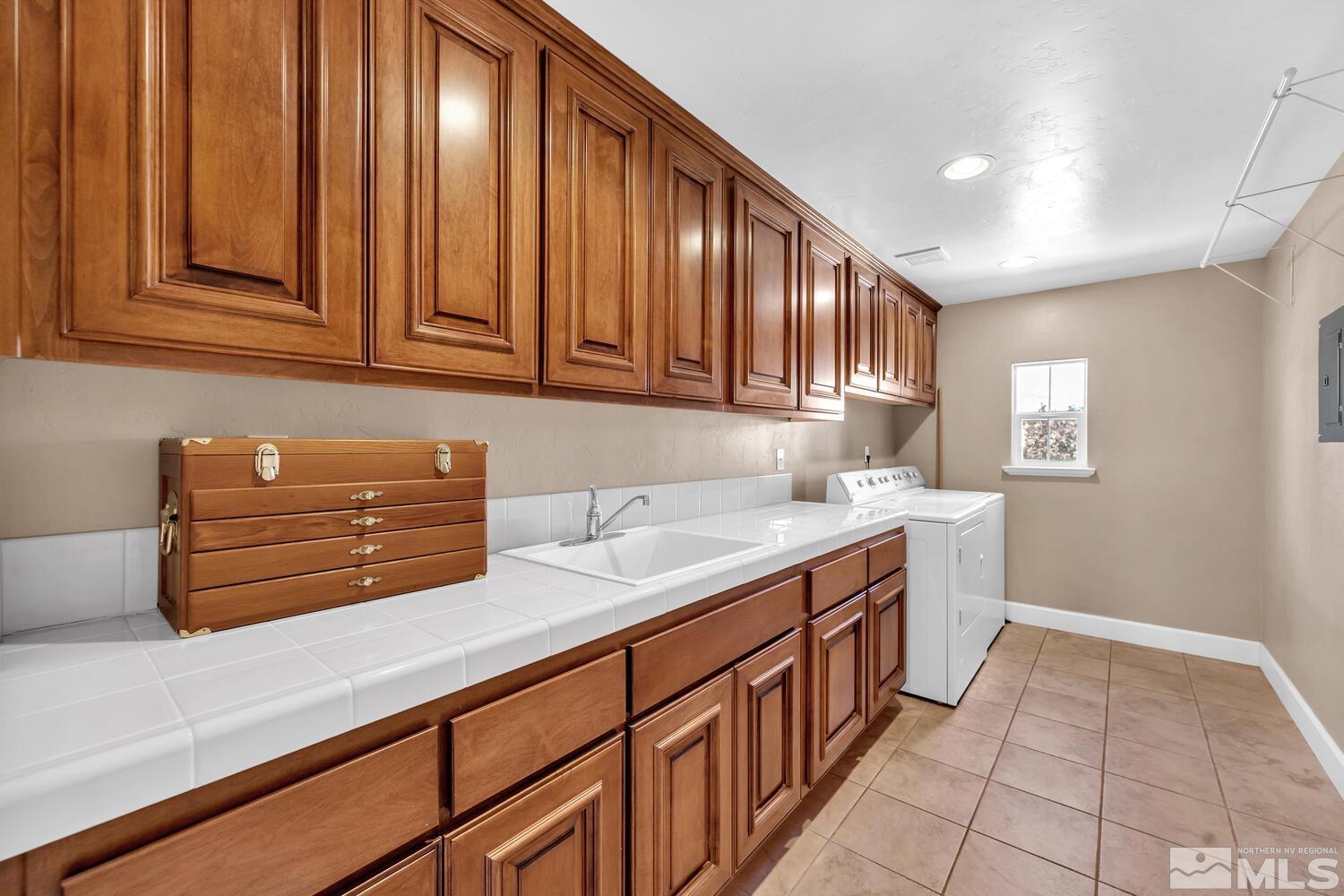 1940 Bechtol Ridge Circle Reno, NV 89523 - Photo 33 of 40 a kitchen with stainless steel appliances granite countertop wooden cabinets a sink and dishwasher