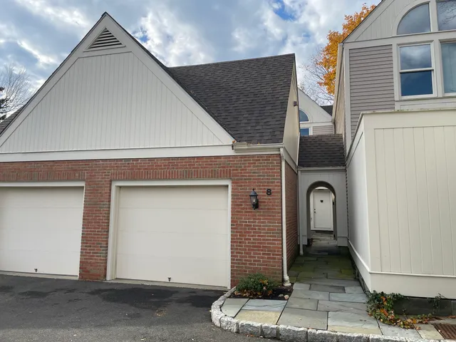 a front view of a house with a garage