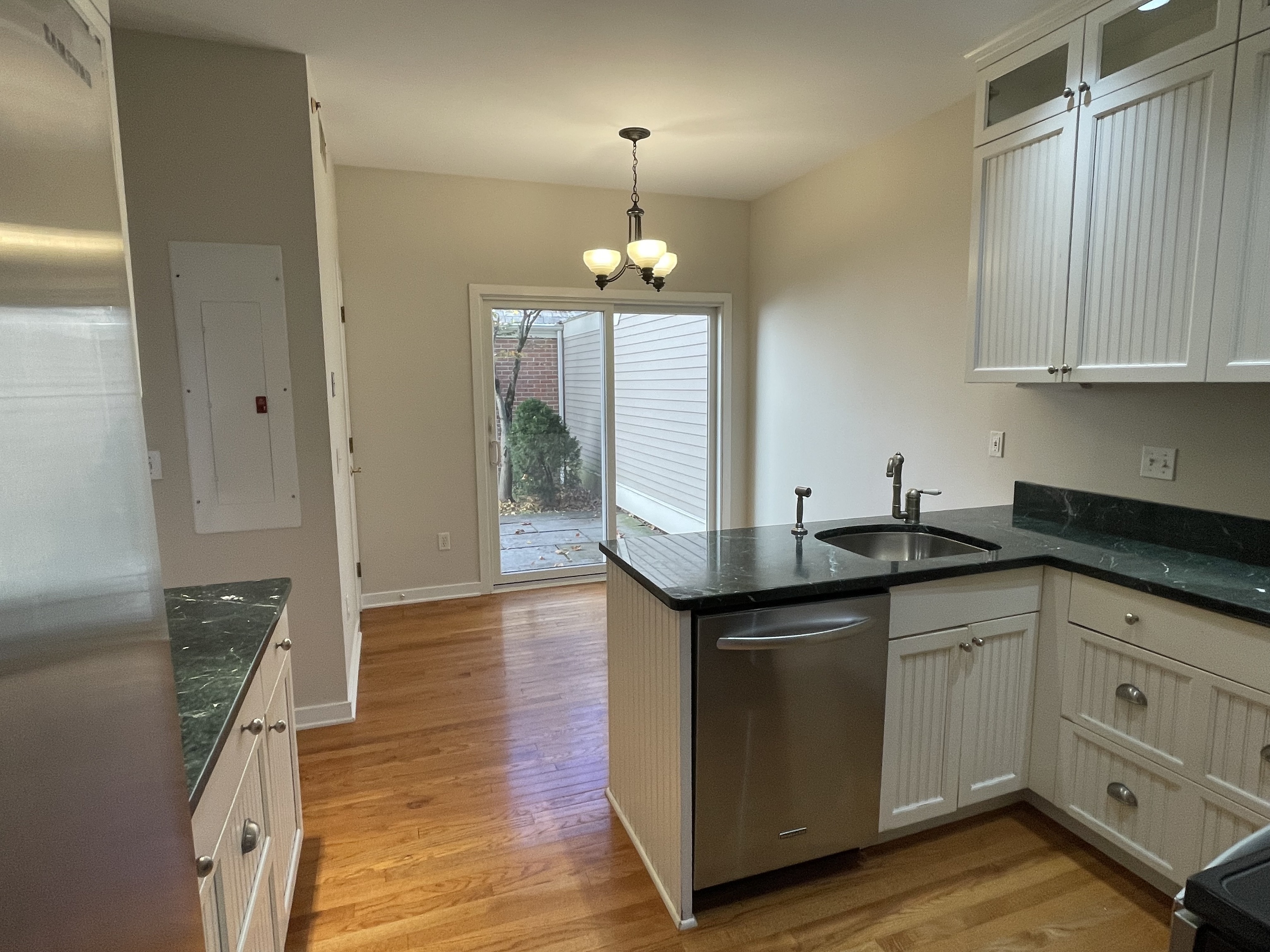 8 Sedgewick Village Lane Darien, CT 06820 - Photo 4 of 15 a kitchen with stainless steel appliances granite countertop a sink and wooden floor