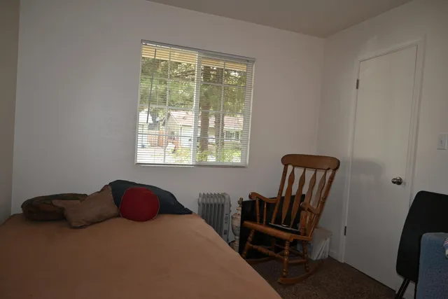 a bedroom with a bed and a window