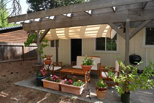a outdoor living space with patio furniture and potted plants