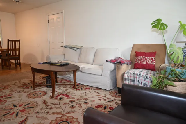 a living room with furniture and flowers