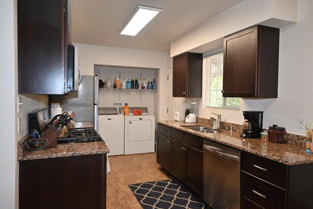 a kitchen with a sink stove and refrigerator