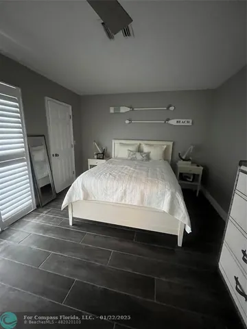 a large bed sitting in a room next to a window