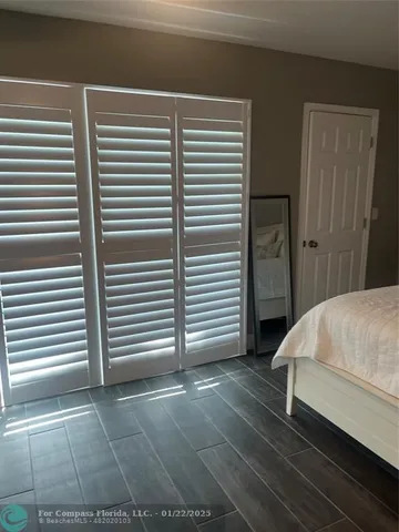 a bedroom with a bed and a white door