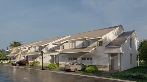 a front view of a building with lots of green space