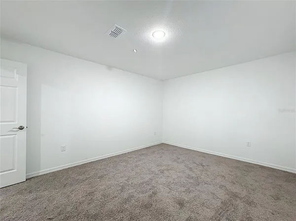 an aerial view of a house with swimming pool and porch