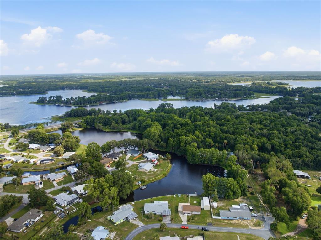 1830 South Mandarin Terrace Inverness, FL 34450 - Photo 29 of 47 an aerial view of lake residential house with outdoor space and trees around