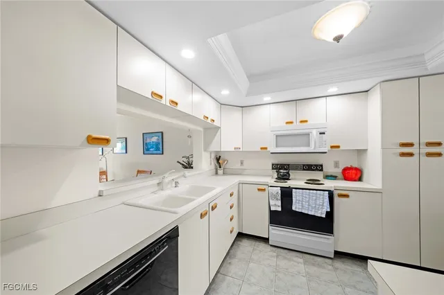 a kitchen with a sink a stove and cabinets
