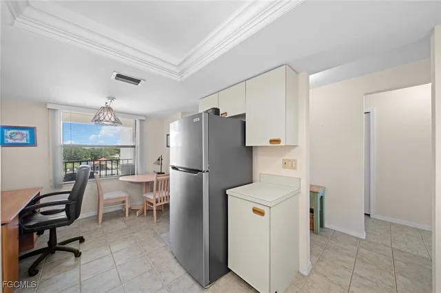 a kitchen with a refrigerator a stove a table and chairs