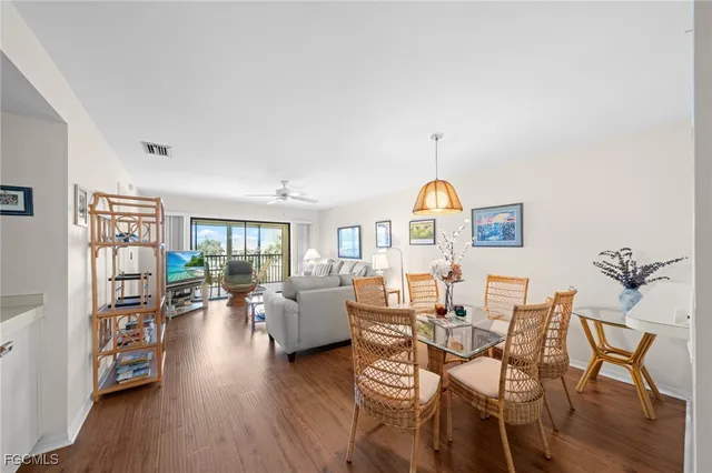 a living room with furniture dining table and wooden floor