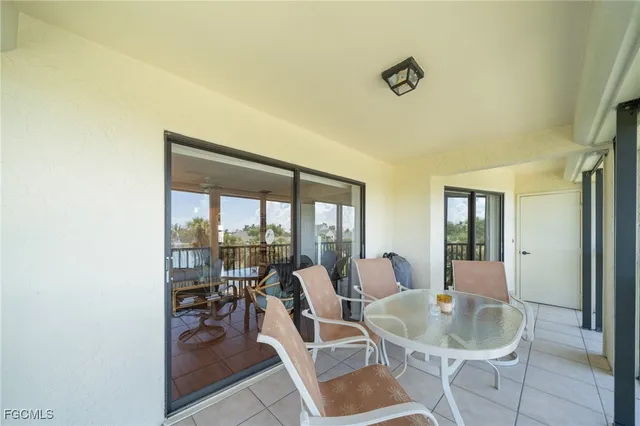 a dining room with furniture and a floor to ceiling window