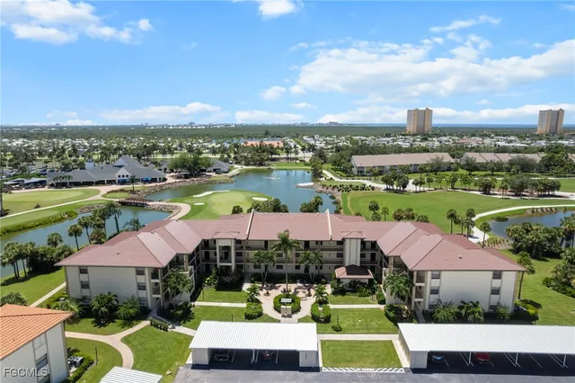 a view of a city with lawn chairs and large trees