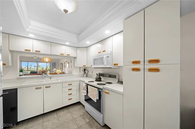 a kitchen with cabinets a sink and appliances