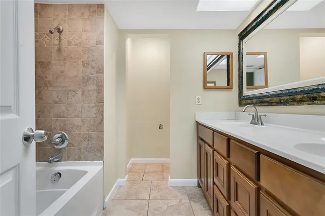 a bathroom with a sink a mirror and a bathtub