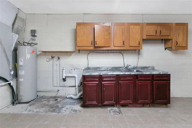 a kitchen with stainless steel appliances granite countertop a refrigerator and cabinets