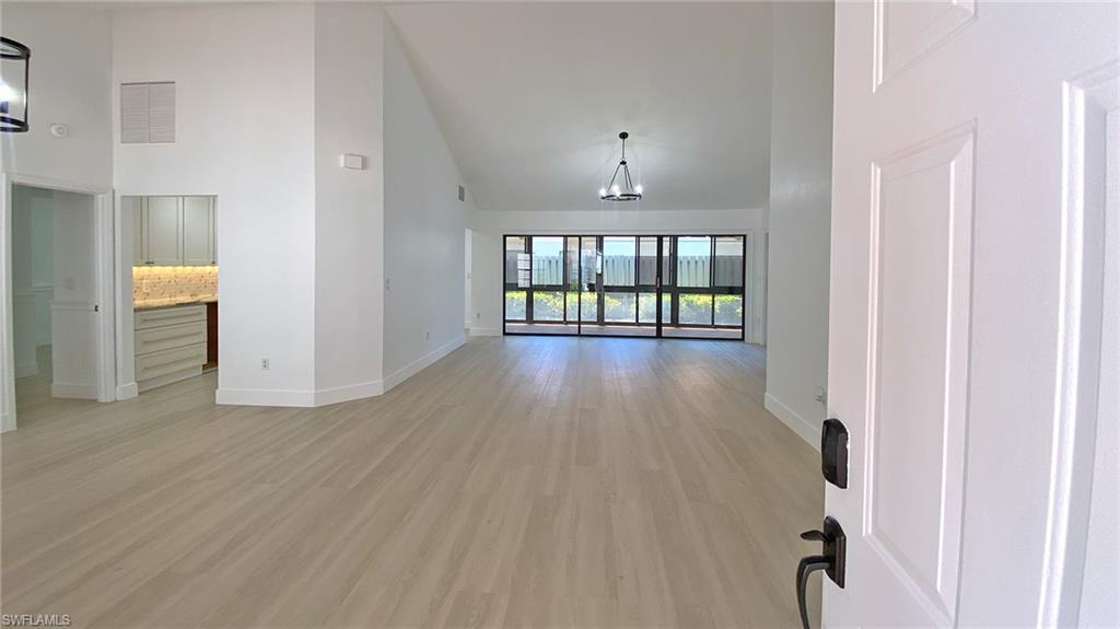718 Reef Point Circle Naples, FL 34108 - Photo 13 of 23 a view of an entryway with wooden floor