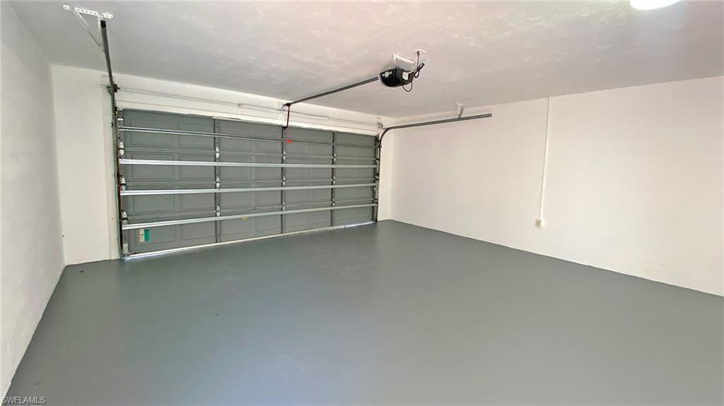 718 Reef Point Circle Naples, FL 34108 - Photo 18 of 23 a view of an empty room with a ceiling fan