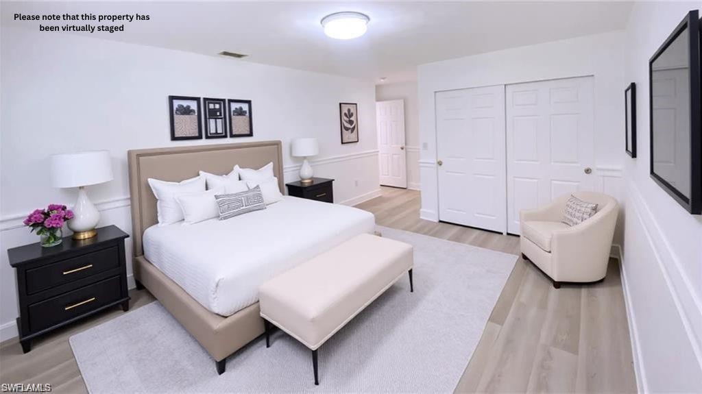 718 Reef Point Circle Naples, FL 34108 - Photo 4 of 23 a bedroom with a bed and a couch