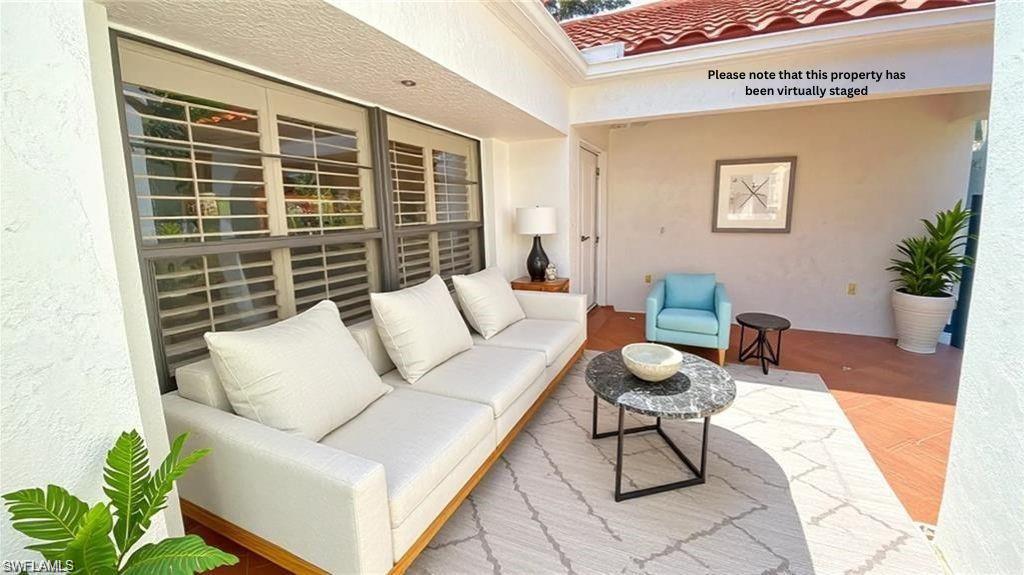 718 Reef Point Circle Naples, FL 34108 - Photo 9 of 23 a living room with furniture and a potted plant