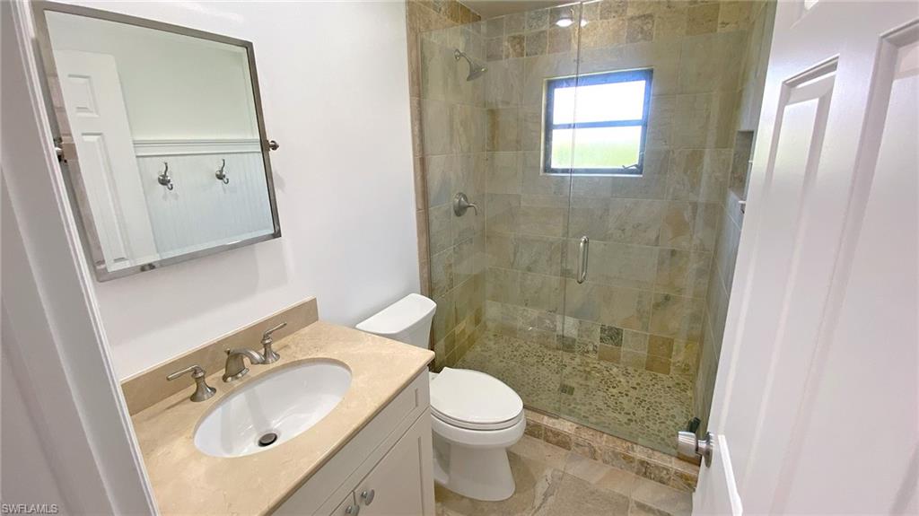 718 Reef Point Circle Naples, FL 34108 - Photo 10 of 23 a bathroom with a sink a toilet and shower