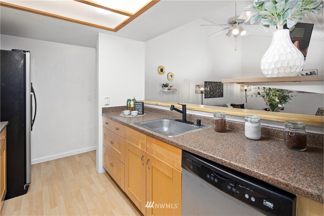 14401 Southeast Petrovitsky Road, Unit B204 Renton, WA 98058 - Photo 14 of 31 a kitchen with sink refrigerator and stove
