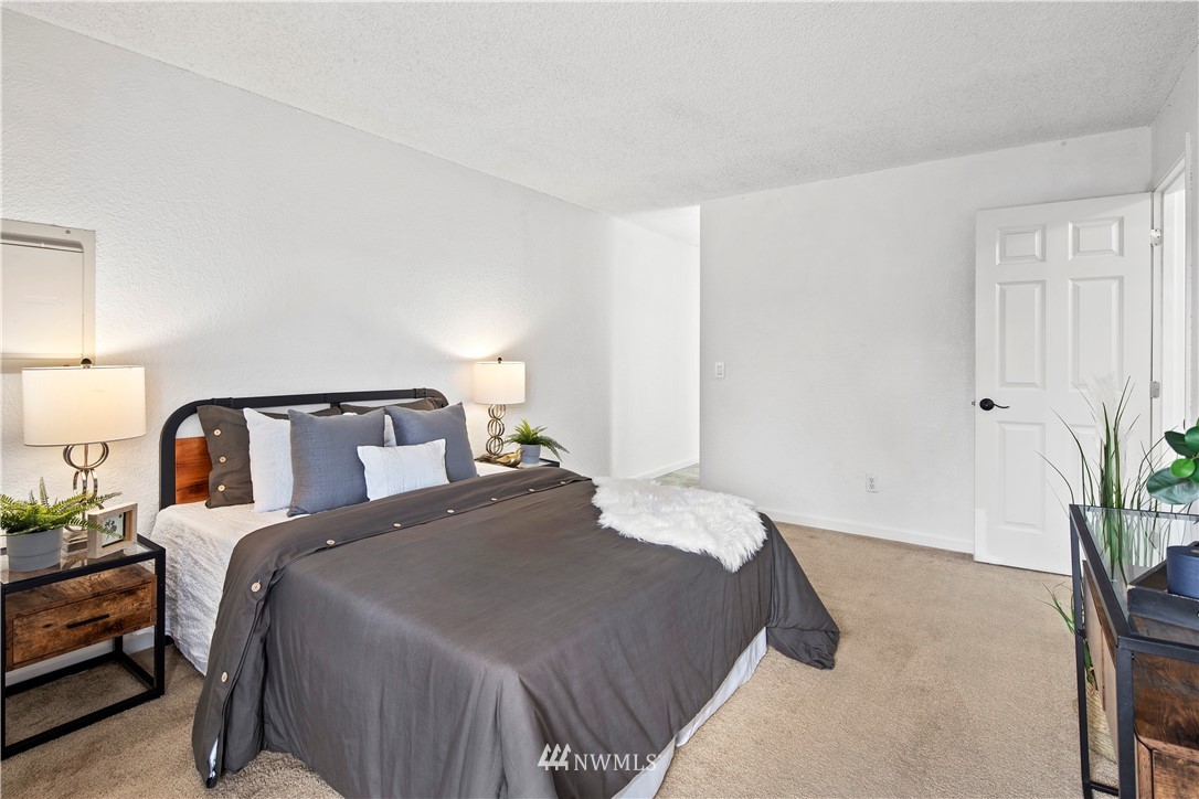 14401 Southeast Petrovitsky Road, Unit B204 Renton, WA 98058 - Photo 16 of 31 a bedroom with a bed and potted plant