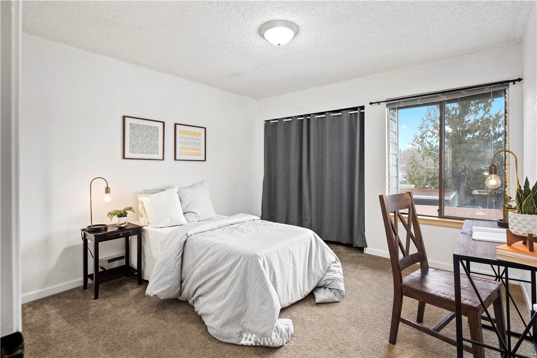 14401 Southeast Petrovitsky Road, Unit B204 Renton, WA 98058 - Photo 20 of 31 a bedroom with a bed and a large mirror