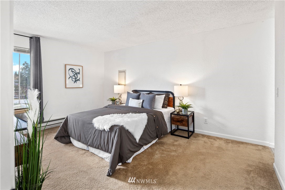 14401 Southeast Petrovitsky Road, Unit B204 Renton, WA 98058 - Photo 4 of 31 a bedroom with a bed and a cabinets