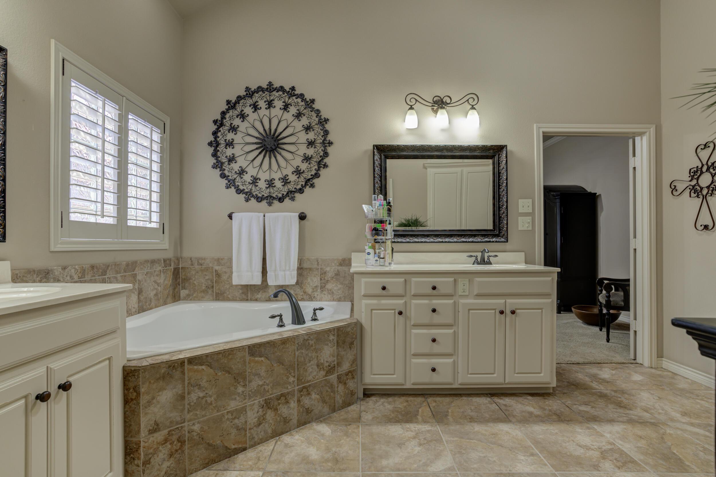 6008 89th Street Lubbock, TX 79424 - Photo 33 of 61 a bathroom with a sink double vanity and a mirror