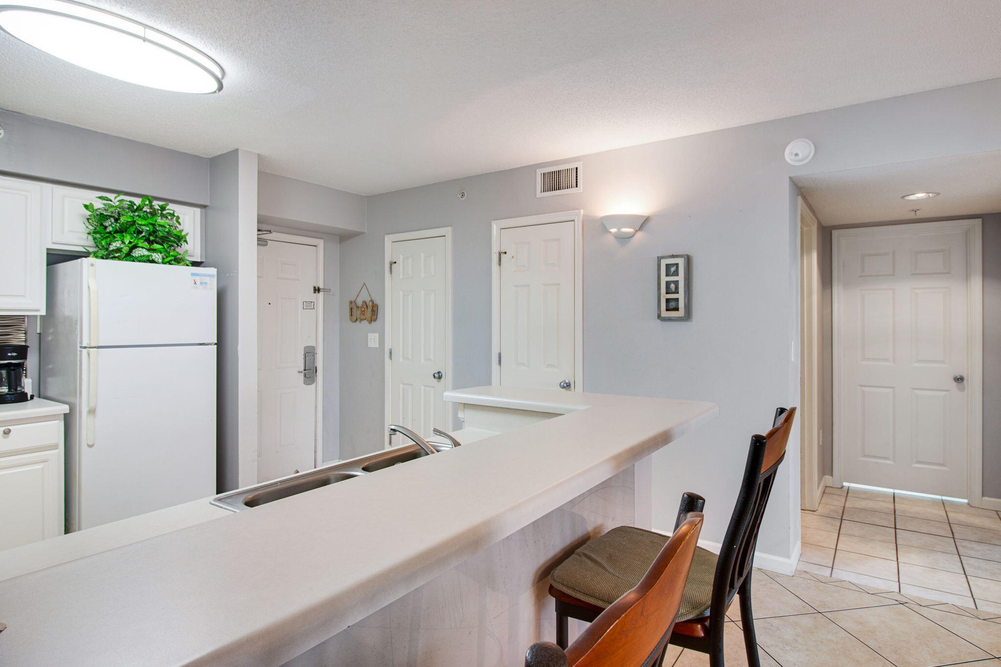 970 Highway 98, Unit 303 Destin, FL 32541 - Photo 19 of 42 a dining hall with a dining table and chairs