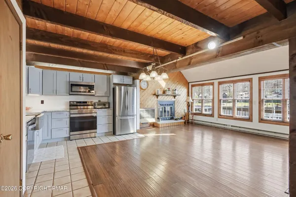 a kitchen with stainless steel appliances granite countertop a refrigerator and a stove top oven