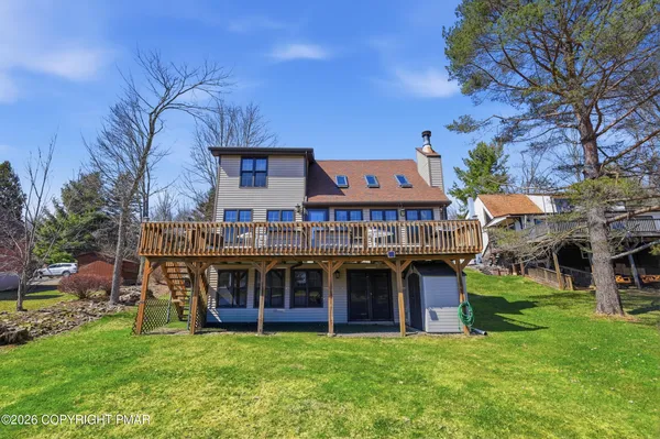 a view of a house with a backyard porch and sitting area