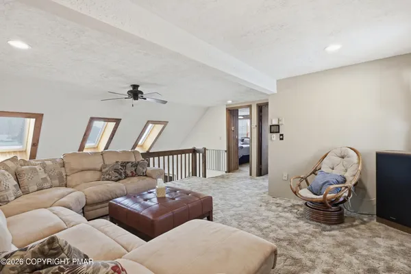 a living room with couches and large windows